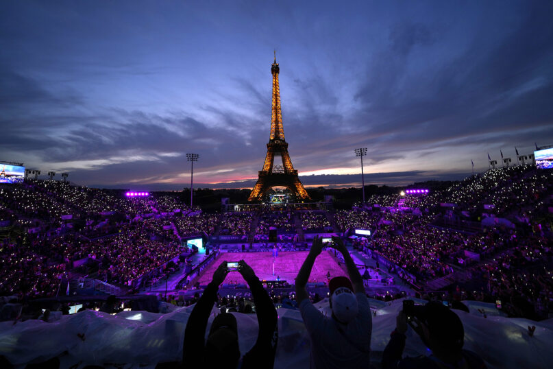 Spectators take photos at Eiffel Tower Stadium during the 2024 Summer Olympics, Saturday, July 27, 2024, in Paris, France. (AP Photo/Robert F. Bukaty)