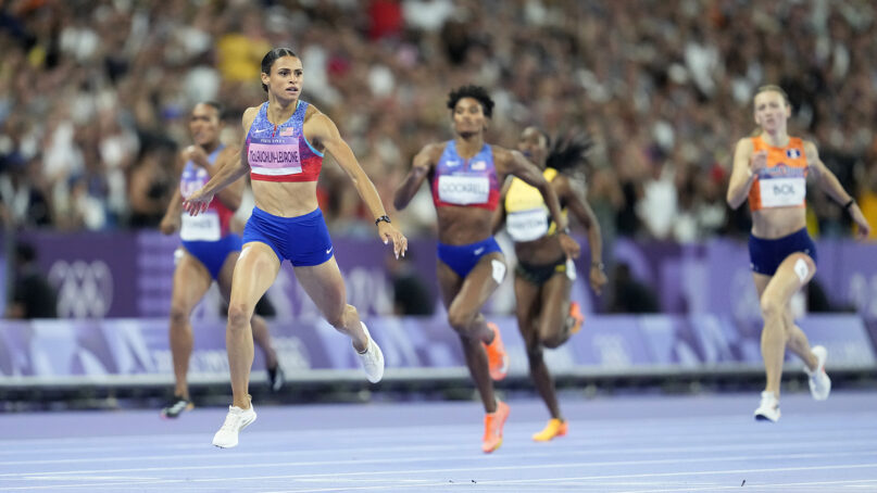 Gold medalist Sydney McLaughlin-Levrone, of the United States, crosses the finish line ahead of silver medalist Anna Cockrell, of the United States, center, and bronze medalist Femke Bol, of the Netherlands, right, in the women's 400 meters hurdles final at the 2024 Summer Olympics, Thursday, Aug. 8, 2024, in Saint-Denis, France. (AP Photo/Ashley Landis)