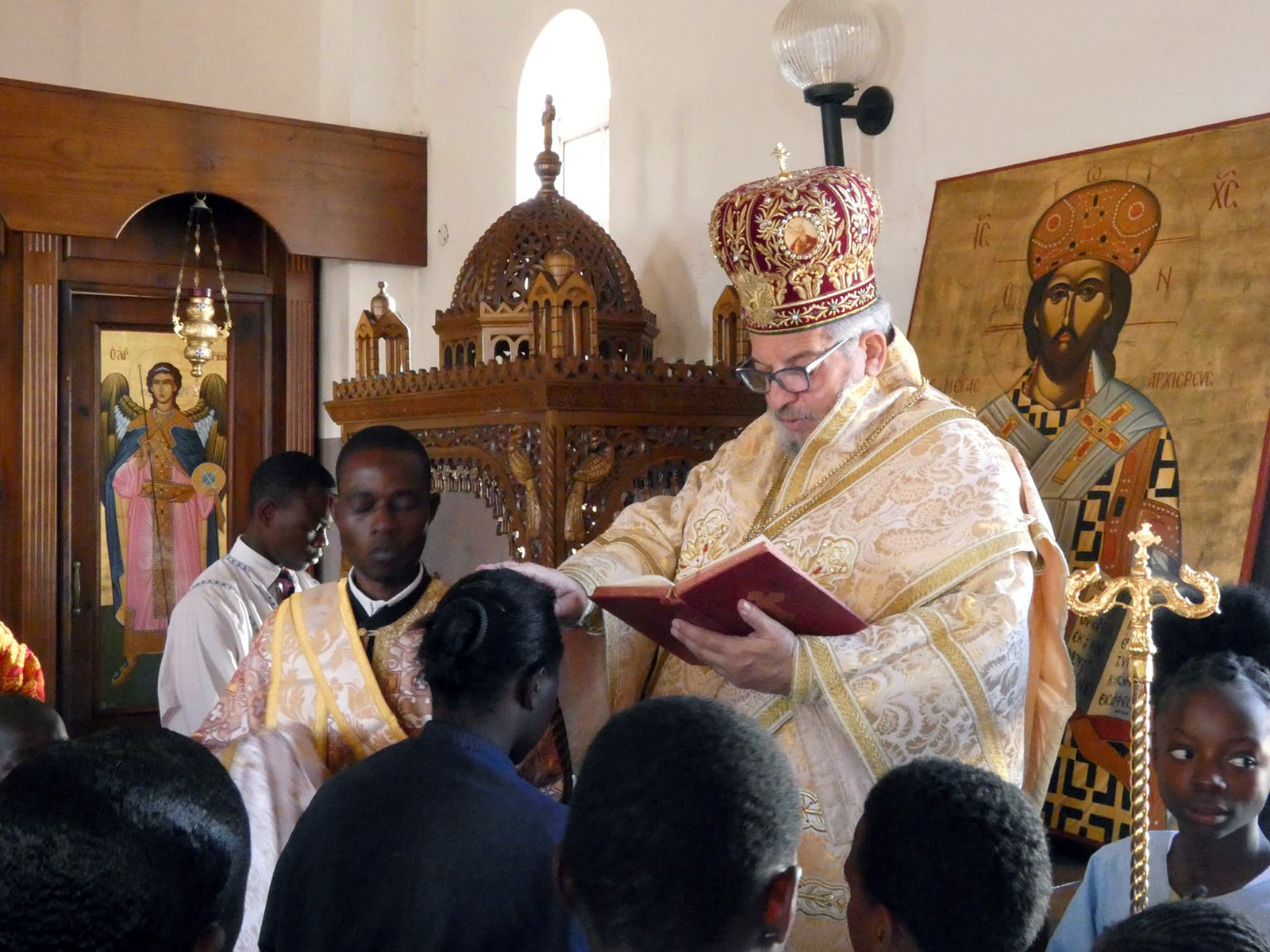 Metropolitan Serafim, right, ordains Angelic Molen, kneeling, as a deaconess at the St. Nektarios Mission Parish near Harare, Zimbabwe, Thursday, May 2, 2024. (St. Phoebe Center/Annie Frost)