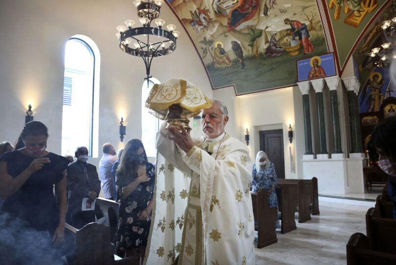 The Rev. Alex Karloutso, vicar-general for the Greek Orthodox Archdiocese of America, presides over a service at the Formation of the Virgin Mary Greek Orthodox Church of the Hamptons on Sunday, Aug. 29, 2021, in Southhampton, N.Y. (AP Photo/Jessie Wardarski)