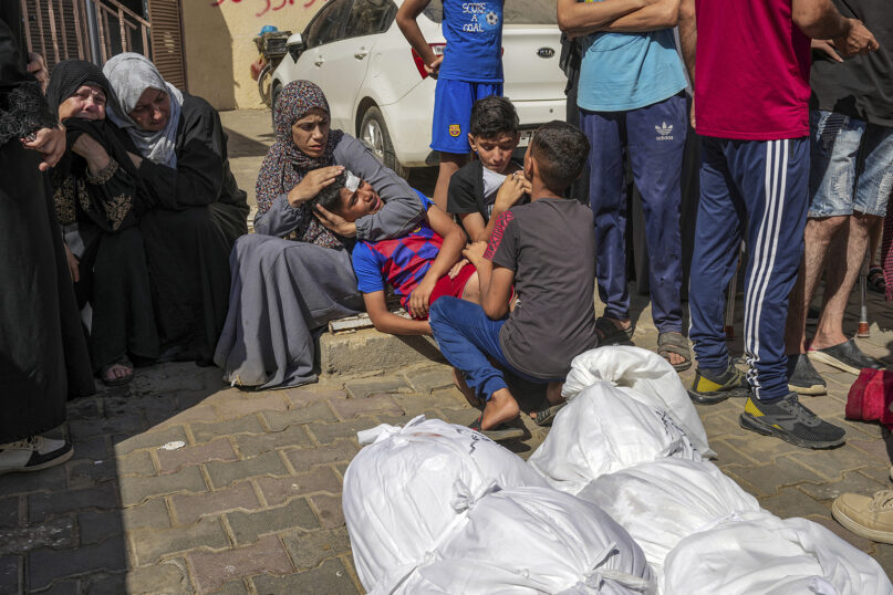 Palestinians mourn their relatives killed in the Israeli bombardment of the Gaza Strip, in a hospital in Deir al Balah on Tuesday, June 18, 2024. (AP Photo/Abdel Kareem Hana)