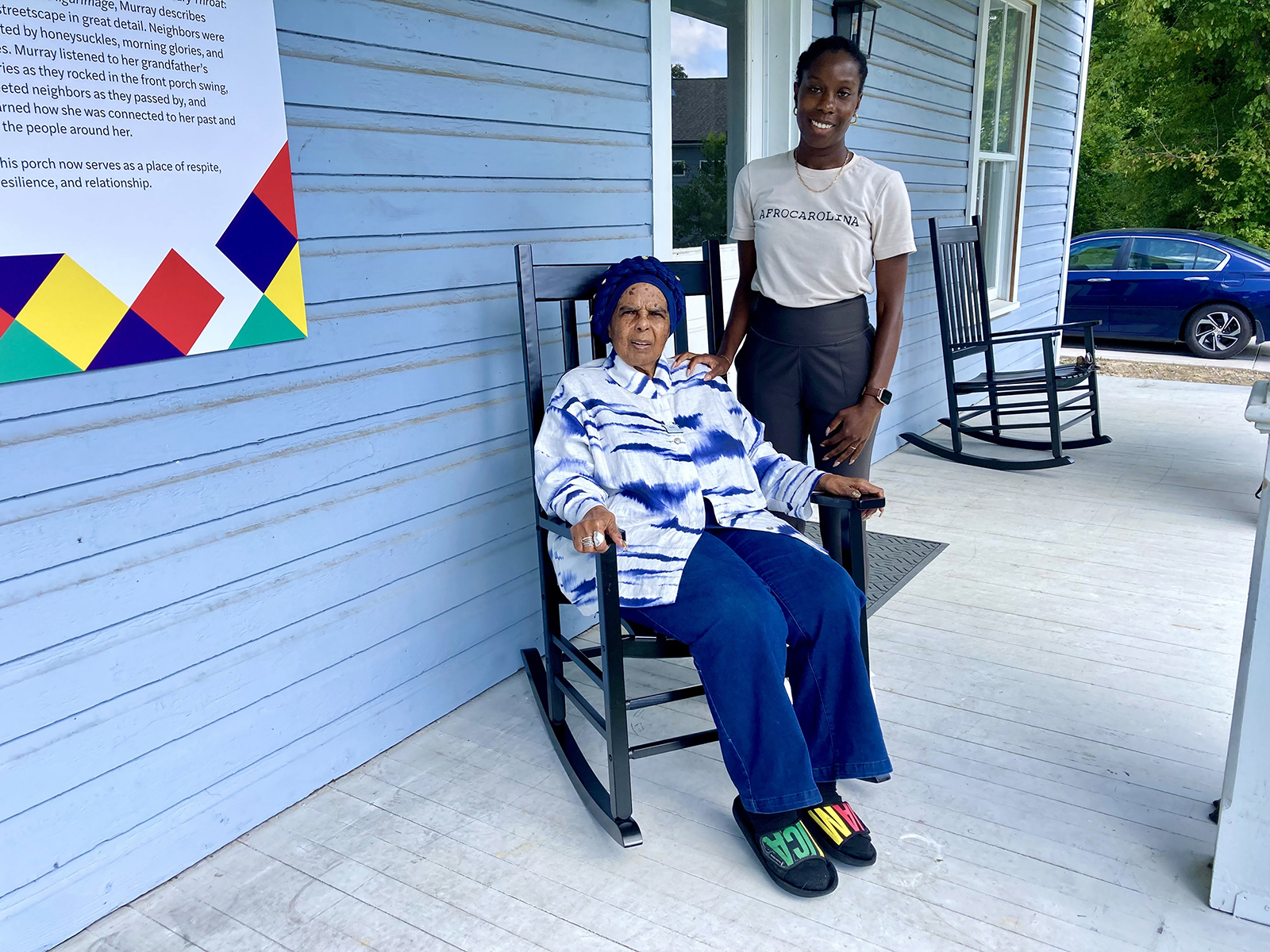 Rosita Stevens-Holsey, Pauli Murray’s niece, sits in a rocking chair on the porch of the house where Murray grew up. Standing beside her is Angela Mason Thorpe, executive director of the Pauli Murray Center for History and Social Justice in Durham, North Carolina, Friday, Sept. 6, 2024. (RNS photo/Yonat Shimron)