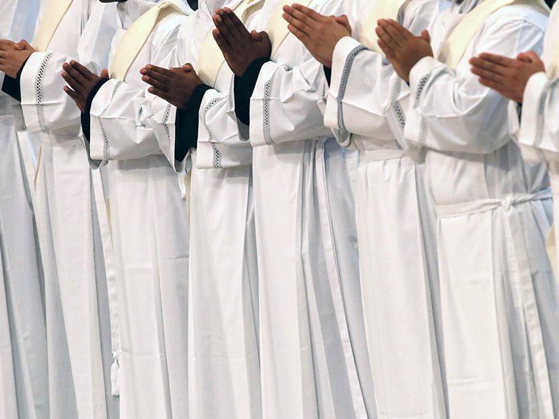 New priests pray during a ceremony in St. Peter's Basilica at the Vatican, on April 22, 2018. Pope Francis reminded priests to always be merciful, as he ordained 16 men in a ceremony in St. Peter's Basilica. In remarks Sunday to the new priests from several nations, Francis said: "Please, don't tire of being merciful" since they themselves sin. (AP Photo/Alessandra Tarantino)