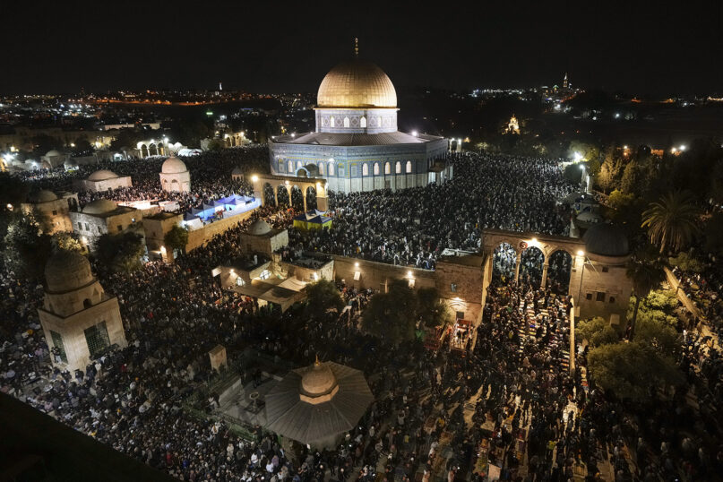 Palestinian Muslim worshippers pray during Laylat Al Qadr, also known as the Night of Power, in front of the Dome of the Rock Mosque, in the Al-Aqsa Mosque compound in Jerusalem's Old City, April 27, 2022. (AP Photo/Mahmoud Illean)