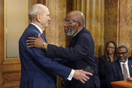 The Rev. Amos C. Brown, right, and President Russell M. Nelson of The Church of Jesus Christ of Latter-day Saints hug during a news conference Monday, June 14, 2021, in Salt Lake City. Top leaders from the NAACP and The Church of Jesus Christ of Latter-day Saints announced $9.25 million in new educational and humanitarian projects as they seek to build on an alliance formed in 2018. (AP Photo/Rick Bowmer)