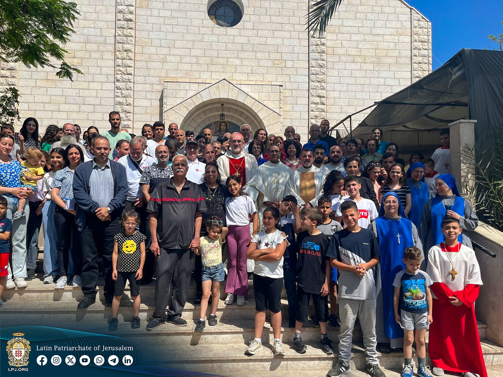 Cardinal Pierbattista Pizzaballa, Latin Patriarch of Jerusalem, center in vestments with red stripe, poses in a group photo with parishioners of the Holy Family Parish in Gaza City on May 16, 2024. (Photo by Issa Anton/Latin Patriarchate of Jerusalem)