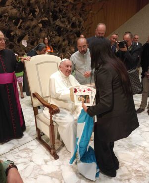 The Rev. Andrea Conocchia, center, introduces members of the Torvaianica transgender community to Pope Francis on Aug. 11, 2022, during the pope’s general audience at the Vatican. (Photo courtesy of Andrea Conocchia)