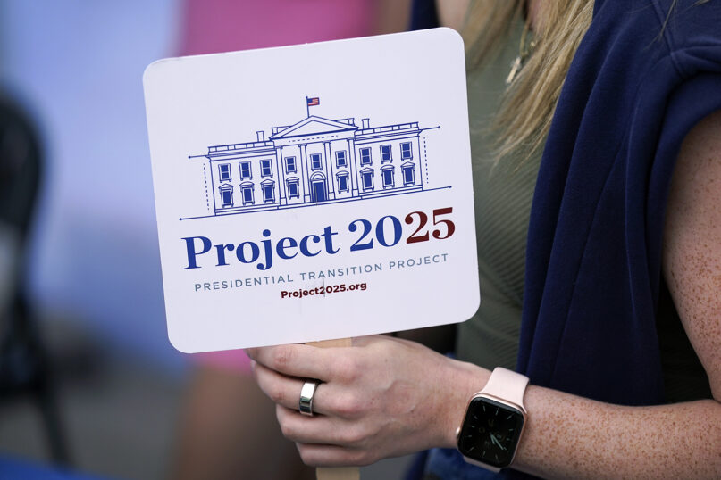 A Project 2025 fan in the group's tent at the Iowa State Fair, Aug. 14, 2023, in Des Moines, Iowa. The Project 2025 effort is being led by the Heritage Foundation think tank. (AP Photo/Charlie Neibergall)