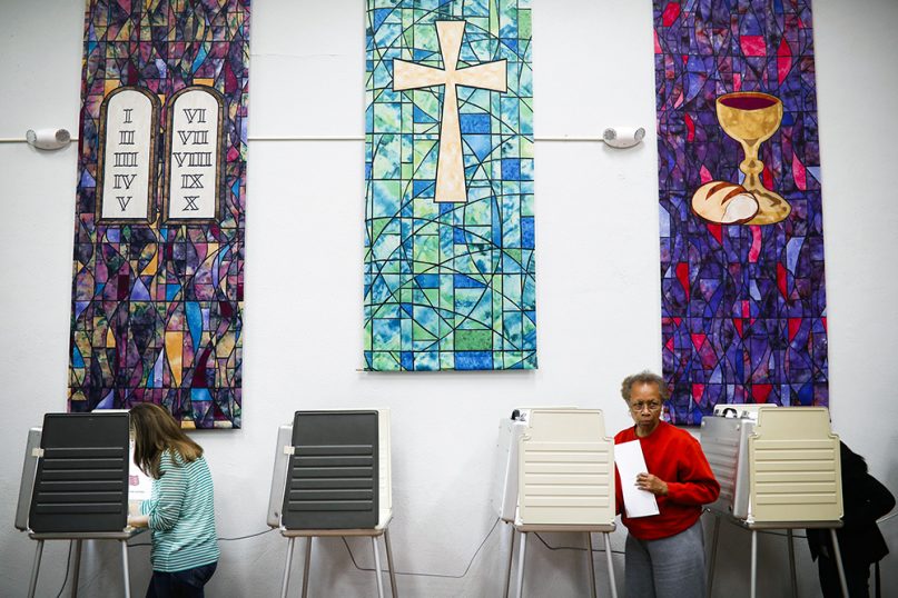 Voters fill out ballots at a polling place inside the Pleasant Ridge Presbyterian Church on Election Day, Nov. 8, 2016, in Cincinnati. (AP Photo/John Minchillo)