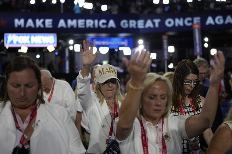 Delegates pray during the Republican National Convention, Tuesday, July 16, 2024, in Milwaukee. (AP Photo/Jae C. Hong)