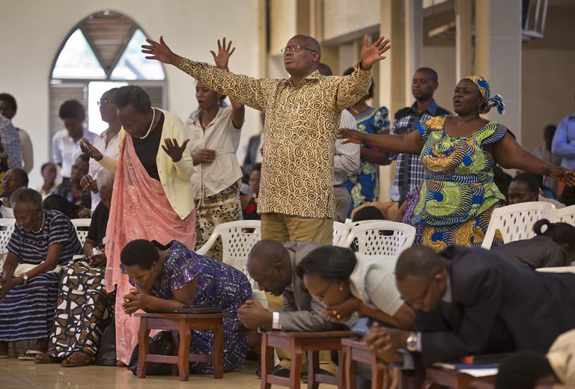 Rwandans sing and pray at the Evangelical Restoration Church in the Kimisagara neighborhood of Kigali, the Rwandan capital, on April 6, 2014. (AP Photo/Ben Curtis)