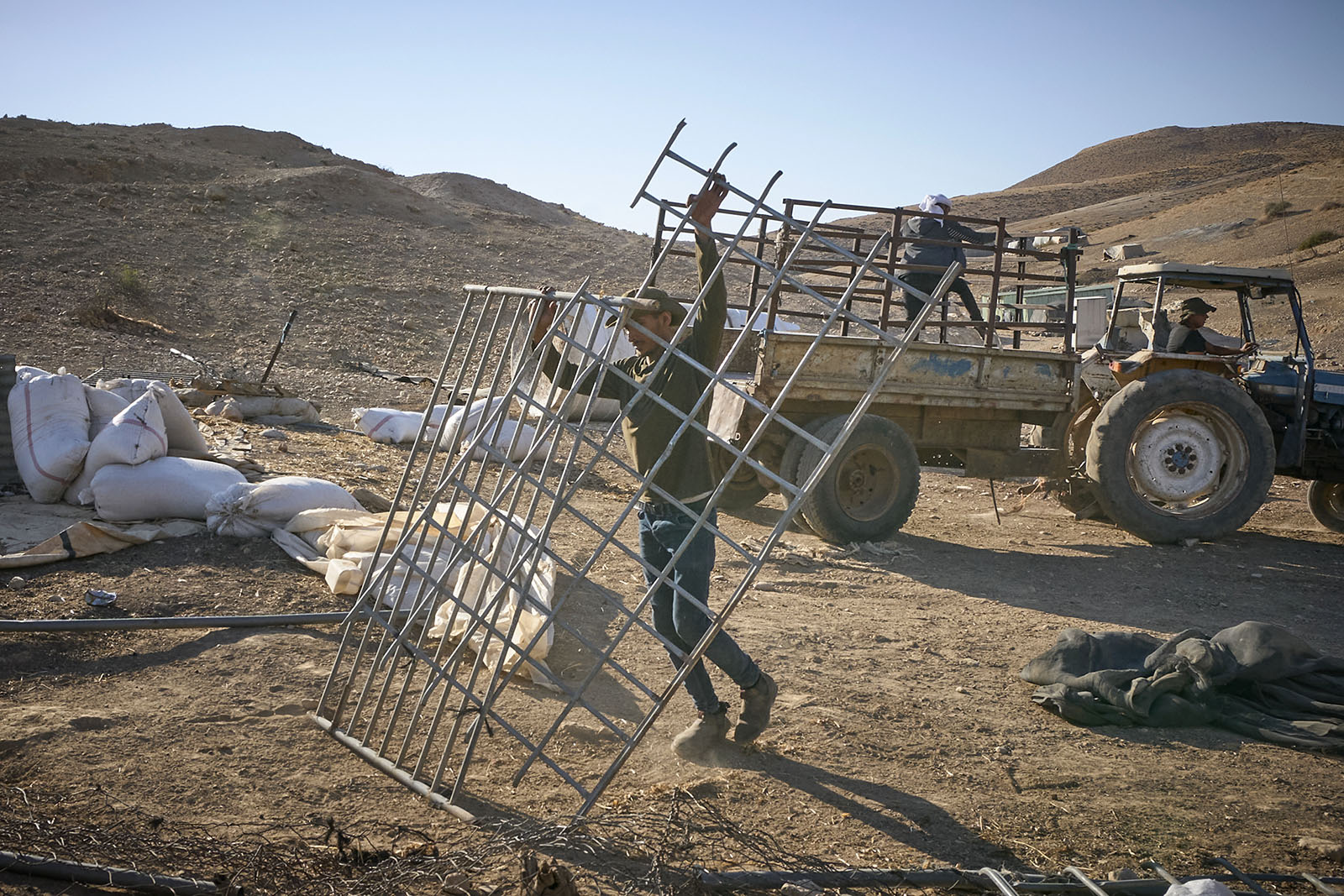 Bedouin sheep farmers in Umm Jamal, a small West Bank village near Nablus, pack up their belongings after being chased off land where they have lived for more than 30 years, Friday, Aug. 16, 2024. Israeli settlers harassed and threatened the families at all hours of the day and night, leading to the Bedouins choosing to leave the land. (Photo © Paul Jeffrey/Life on Earth Pictures)