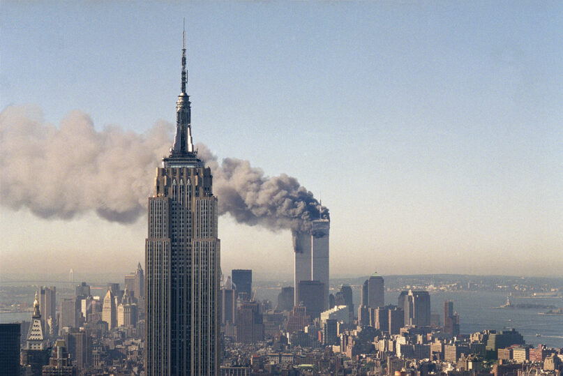 The twin towers of the World Trade Center burn behind the Empire State Building, Sept. 11, 2001, in New York. (AP Photo/Marty Lederhandler, File)