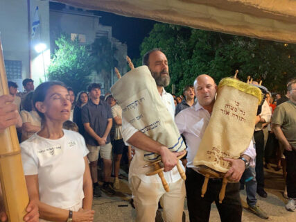 Rachel Goldberg, left in white, and her husband, Jon Polin, center, dedicate a Torah scroll in the merit of their son, Hersh Goldberg-Polin, during a Week of Goodness event in Jerusalem, Thursday, July 18, 2024. (Courtesy photo)