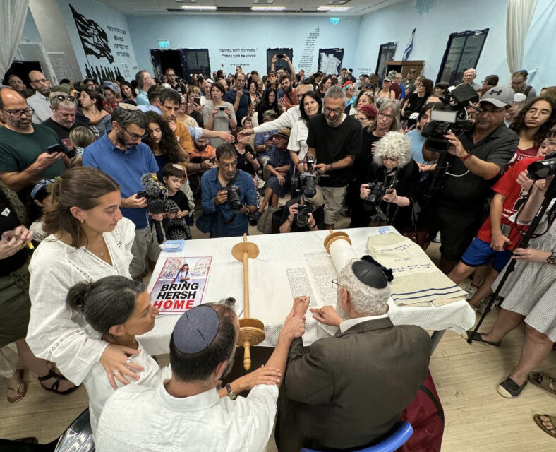 Rachel Goldberg and Jon Polin watch as a scribe completes the Torah they commissioned and dedicated in the merit of their son, Hersh Goldberg-Polin, and other hostages held by Hamas. The last 120 letters represented the 120 hostages, both alive and dead, still imprisoned in Gaza. The Torah was dedicated  Thursday, July 18, 2024, during Week of Goodness events in Jerusalem. (Courtesy photo)