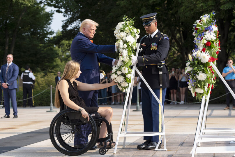 Former U.S. Marine Corps Cpl. Kelsee Lainhart, left, and Republican presidential nominee former President Donald Trump place a wreath at the Tomb of the Unknown Soldier at Arlington National Cemetery, Aug. 26, 2024, in Arlington, Va., in honor of the 13 service members killed at Abbey Gate in Afghanistan. (AP Photo/Alex Brandon)