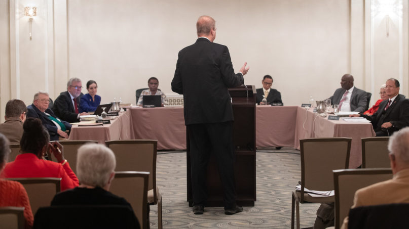 Bishop Kenneth H. Carter (standing) speaks during an oral hearing before the United Methodist Judicial Council meeting in Evanston, Ill. Carter is president of the denomination's Council of Bishops. Photo by Mike DuBose/UM News