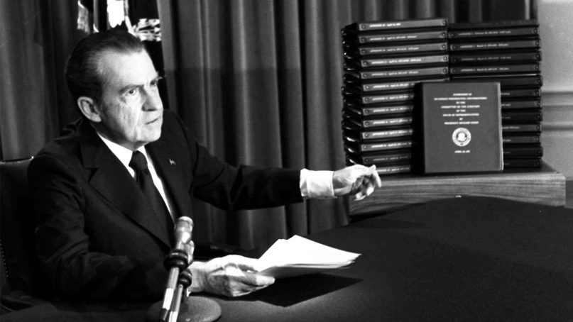 President Richard Nixon gestures toward transcripts of White House tapes after announcing he would turn them over to House impeachment investigators and make them public in April of 1974. (AP Photo)