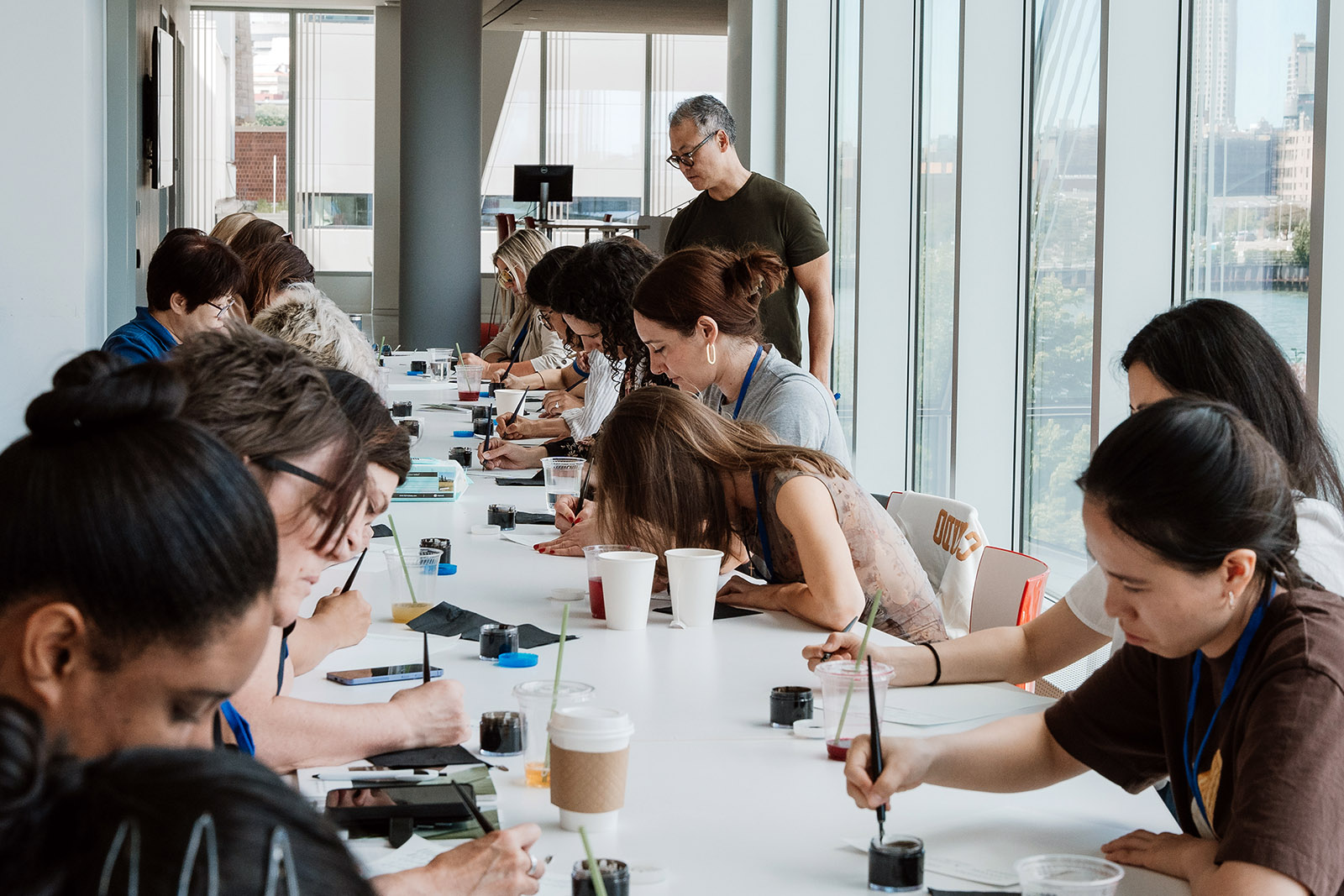 People attend a session titled "Cultivating Mindfulness | The Sacred Art of Calligraphy" during The Well's holistic wellness retreat at the Tata Innovation Center, Saturday, June 8, 2024, on Roosevelt Island in New York City. (Photo by AnnAnn Puttithanasorn)