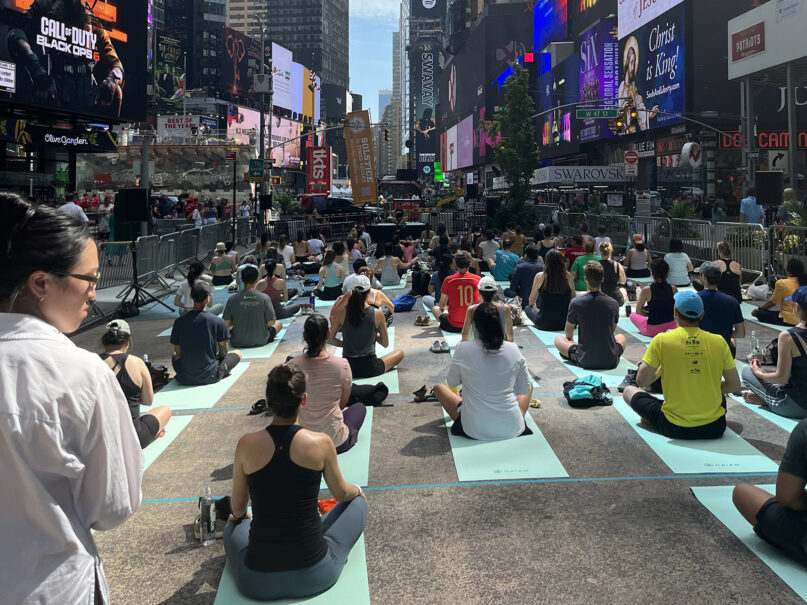 People practice yoga in Times Square, Thursday, June 20, 2024, in New York. (Photo courtesy Nikita Bhasin)