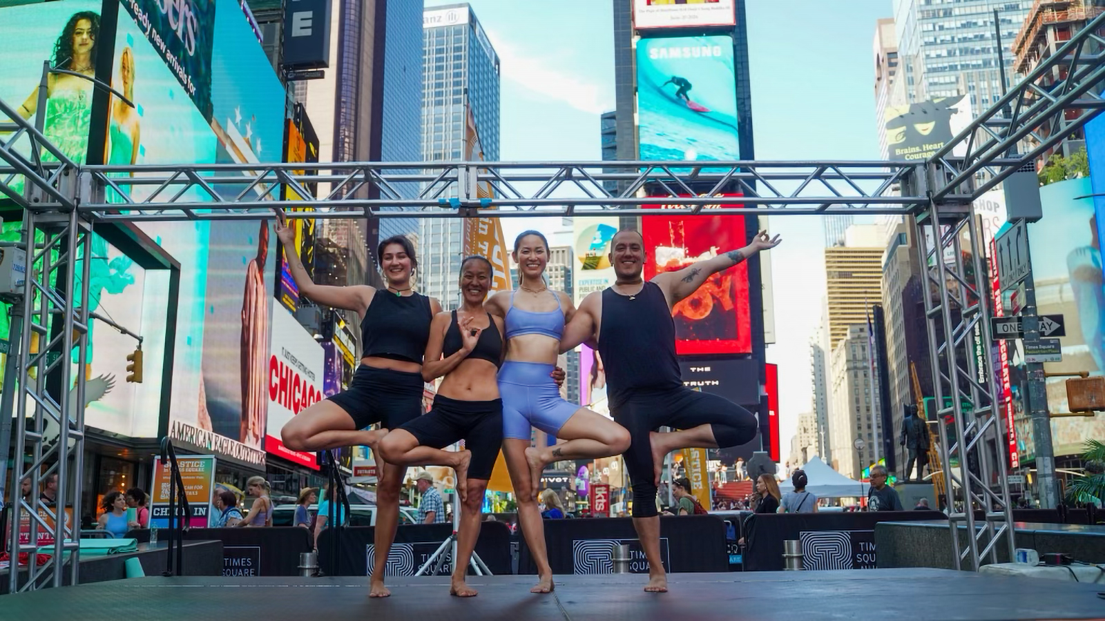 Nikita Bhasin, from left, Pooja Tuladhar, Susan Hu (Brinda Kumari Devi Dasi), and Kevin Tobar (Kishor Chandra Das) instructed a yoga session in Times Square on Thursday afternoon, June 20, 2024, in New York. (Photo courtesy Bruno Calvis)