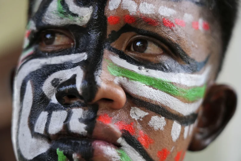 A man, his face painted in the likeness of a spirit, participates in the He Neak Ta rituals in Phum Boeung village, northwest of Phnom Penh, Cambodia, Tuesday, June 11, 2024. (AP Photo/Heng Sinith)